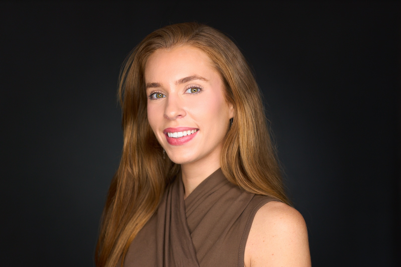 Corporate portrait with polished wardrobe on a dark studio background in Sydney